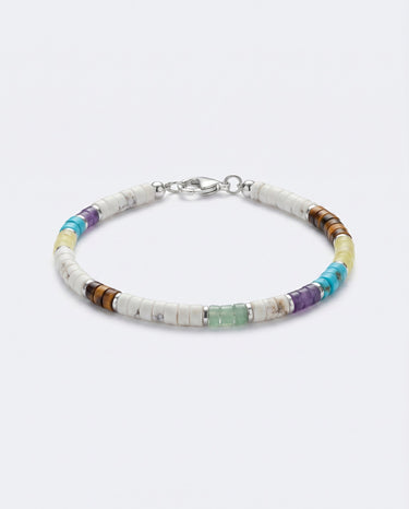 A studio product shot of a 4mm mixed gemstone heishi bracelet featuring white turquoise, tiger's eye, and amethyst, with sterling silver flat rondel beads for a refined, colorful aesthetic.