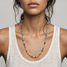 A woman wearing a 4mm millefiori round bead necklace, showcasing the vibrant colorful  glass beads against a white tank top for an editorial, sophisticated look.