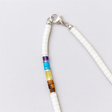 A detailed close-up of the polished sterling silver lobster clasp closure and the high-polish finishing beads on the Multi-Gemstone Heishi Bead Necklace.
