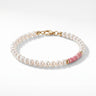 A studio product shot of a women's 4mm natural pearl and rhodonite bead bracelet with a 14K gold-filled clasp, featuring high-luster pearls accented by soft pink gemstone tones.