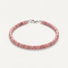 A studio product shot of a women's 4mm natural rhodonite heishi bead bracelet with a sterling silver lobster clasp, highlighting the soft rose-pink gemstone tones and disk-shaped stones.
