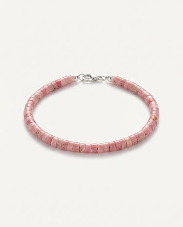 A studio product shot of a women's 4mm natural rhodonite heishi bead bracelet with a sterling silver lobster clasp, highlighting the soft rose-pink gemstone tones and disk-shaped stones.
