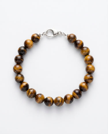 A studio product shot of a women's 8mm natural tiger's eye bead bracelet with a sterling silver lobster clasp.