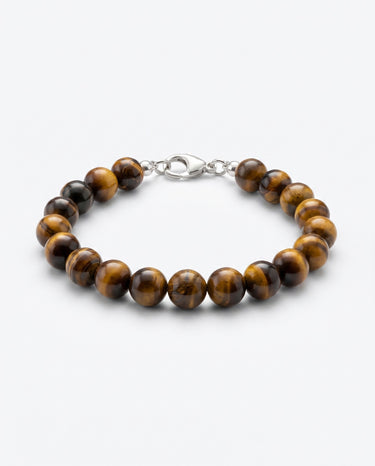 A studio product shot of a women's 8mm natural tiger's eye bead bracelet with a sterling silver lobster clasp on a light gray background.