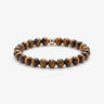 A studio product shot of a women's 6mm tiger's eye bead stretchy bracelet featuring a single sterling silver accent bead.