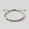 Studio product shot of adjustable chrysoprase heishi bracelet with sterling silver accents, amethyst and pink rhodonite beads, sliding knot closure, and  matching gemstone dangles.