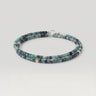 A double-strand beaded necklace made of faceted blue-green gemstone beads with silver spacer beads and a silver clasp, shown on a light gray background.