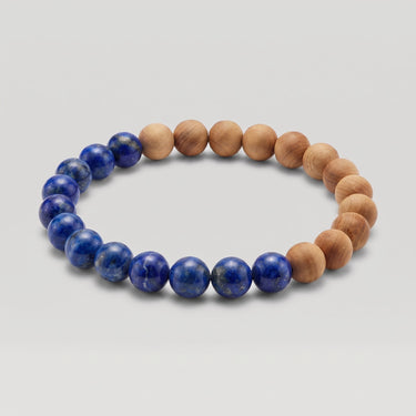 Studio product shot of an 8mm handcrafted bead bracelet featuring half natural lapis lazuli beads and half golden sandalwood beads on a clean white background.