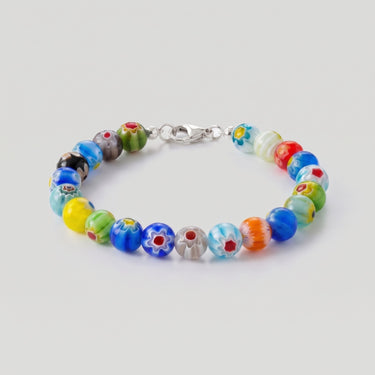A studio product shot of an 8mm handmade Millefiori glass bead bracelet with a sterling silver clasp, highlighting the intricate floral detail and timeless craftsmanship of the glass beads.