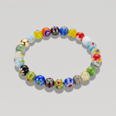 A studio product shot of a 8mm handmade Millefiori glass bead stretchy  bracelet featuring a 14K gold-filled accent bead, showcasing vibrant multi-colored floral patterns.