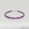 A beaded bracelet made of small amethyst heishi gemstone beads with a silver clasp, on a light gray background.