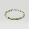 A studio product shot of a woman's 4mm African green chrysoprase heishi bead bracelet featuring a genuine sterling silver lobster clasp, highlighting the disk shape and matte natural stone texture.