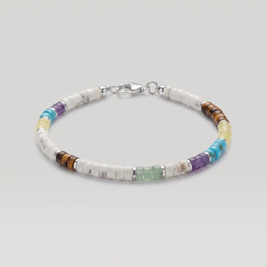 A studio product shot of a 4mm mixed gemstone heishi bracelet featuring white turquoise, tiger's eye, and amethyst, with sterling silver flat rondel beads for a refined, colorful aesthetic.
