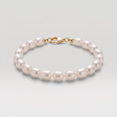 A studio product shot of a 7-8mm natural white baroque freshwater pearl bracelet with a 14K gold-filled clasp, highlighting the individual character and high-shine finish of each pearl.