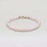A studio hero shot of a 4-5mm natural white baroque freshwater pearl bracelet, showcasing the unique organic shapes and luminous luster of the dainty pearls.