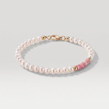 A studio product shot of a women's 4mm natural pearl and rhodonite bead bracelet with a 14K gold-filled clasp, featuring high-luster pearls accented by soft pink gemstone tones.