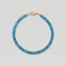 A studio product shot of a women's AAA natural teal blue apatite faceted 2-3mm cube beads bracelet with 14k gold-filled lobster clasp.