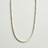 A professional studio hero shot of the women's 4x2mm white turquoise heishi necklace arranged in a U-shape against a neutral background, highlighting the uniform disc shape and crisp white color.
