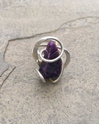 Close-up of the radiant purple Charoite stone showing its natural patterns and the high-gloss polished silver wirework.