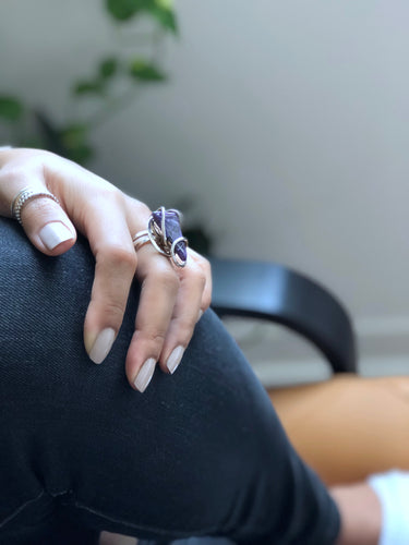 Side view of the floating wave setting, showing the sterling silver wire loops and the adjustable ring band.