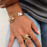 Model wearing a sculptural 14k gold-filled statement ring featuring an abstract wire-formed wave design