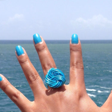 Turquoise anodized aluminum wire wrap ring.

