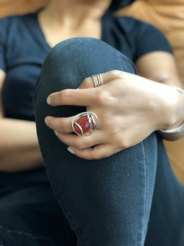 Front view of oval Carnelian Wave Ring with hammered sterling silver wire-wrapped setting.