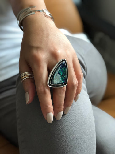 Chrysocolla statement ring in sterling silver worn on hand with soft natural lighting