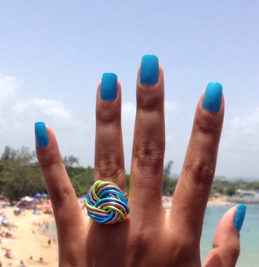 Light green, pink, and turquoise color anodized aluminum wire wrap ring. 
