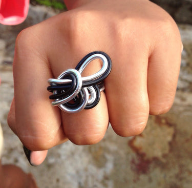 Silver and black anodized aluminum wire wrap ring.

