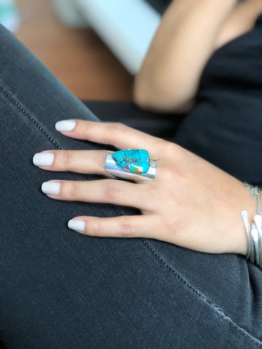 Close-up of freeform turquoise stone in sterling silver shield ring