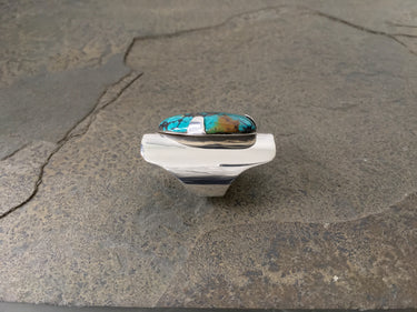 Side profile of turquoise shield ring with tapered sterling silver band