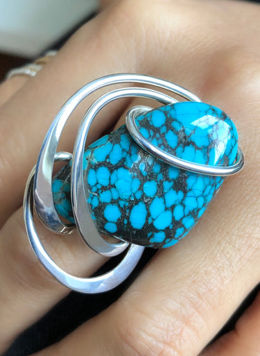 Close-up of freeform Turquoise cabochon with polished and hammered portion sterling silver wire wrap