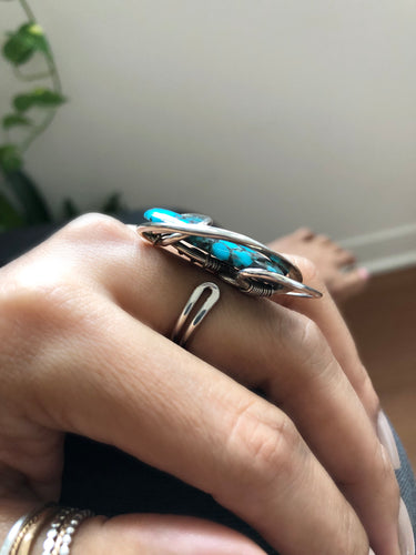 Side view of Phuket Turquoise Wave Ring showing adjustable feature and sculptural hammered sterling silver wire setting