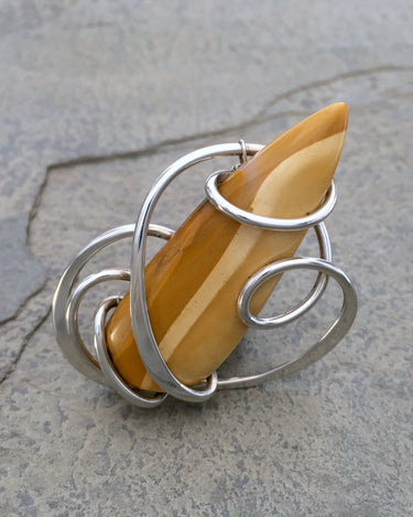 Detail of adjustable sterling silver ring with natural yellow jasper stone centerpiece