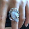 Close-up of Rainbow Moonstone Wave Ring with hammered and polished sterling silver wire wrap. 
