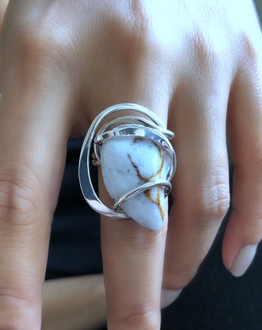 Close-up of Rainbow Moonstone Wave Ring with hammered and polished sterling silver wire wrap. 