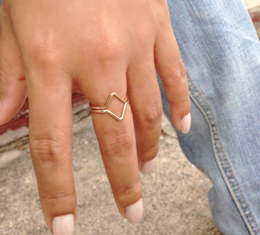 Close-up of Cairo ring set showing hammered flattened open ends and geometric triangle design